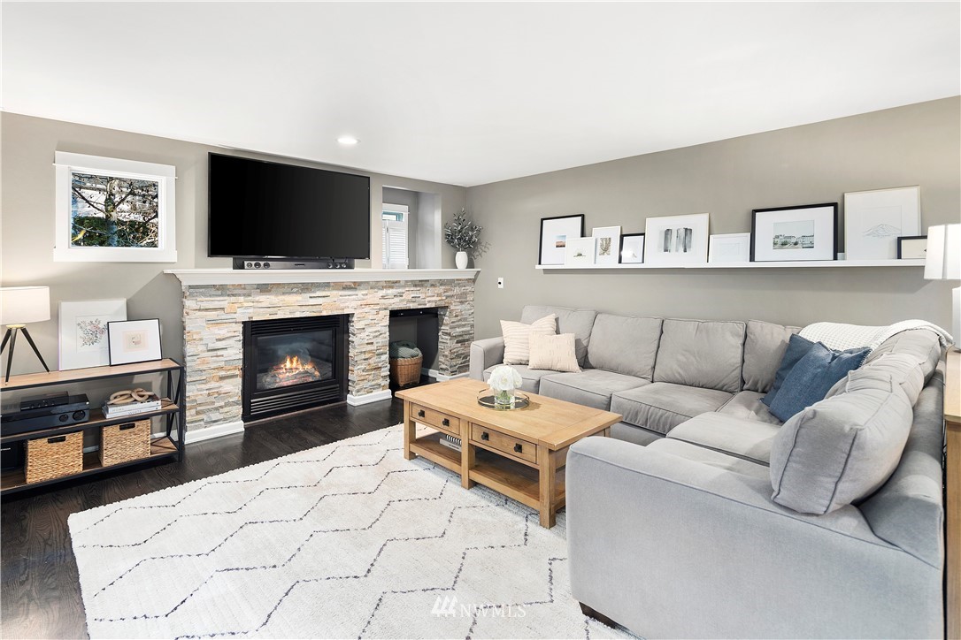 3121 210th Street Southeast Bothell, WA 98021 - Photo 18 of 40 a living room with furniture a flat screen tv and a fireplace