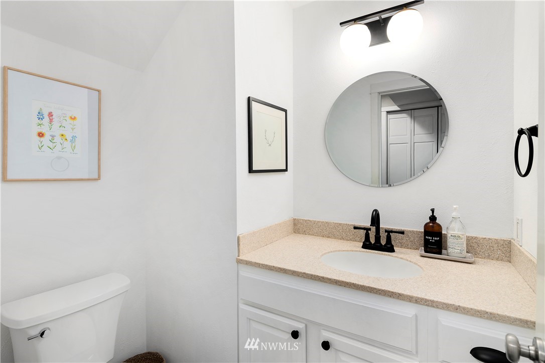 3121 210th Street Southeast Bothell, WA 98021 - Photo 21 of 40 a bathroom with a toilet a sink and mirror