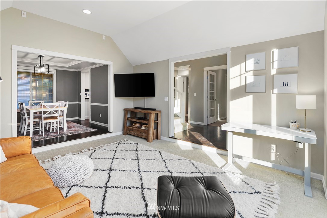 3121 210th Street Southeast Bothell, WA 98021 - Photo 8 of 40 a living room with furniture a flat screen tv and a large window