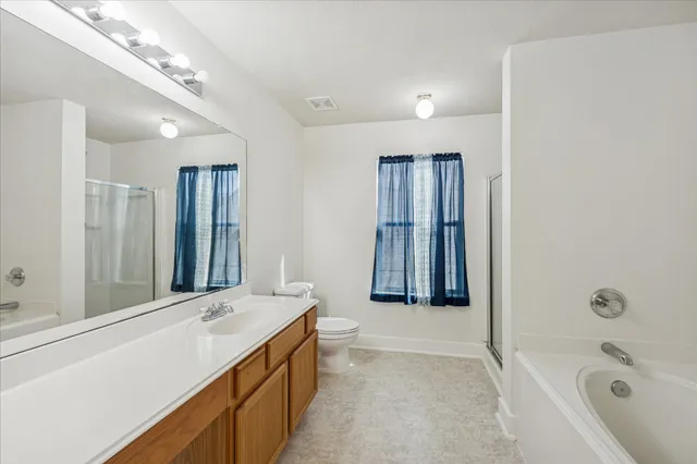 a bathroom with a tub sink and mirror