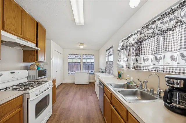 a kitchen with stainless steel appliances granite countertop a sink stove and cabinets
