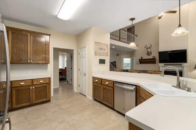 a kitchen with stainless steel appliances a sink a stove and a refrigerator
