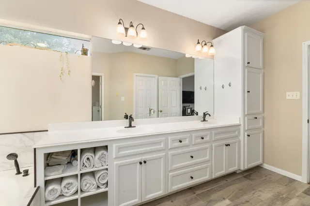 a spacious bathroom with a granite countertop sink mirror and double
