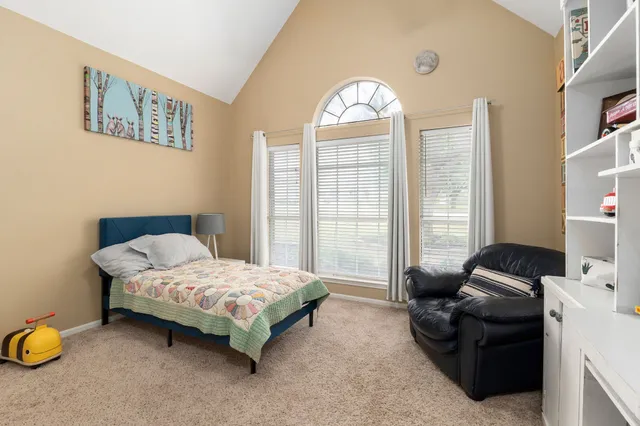 a bedroom with a bed and a couch