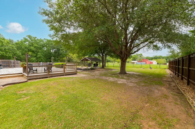 a view of yard with swimming pool and trees