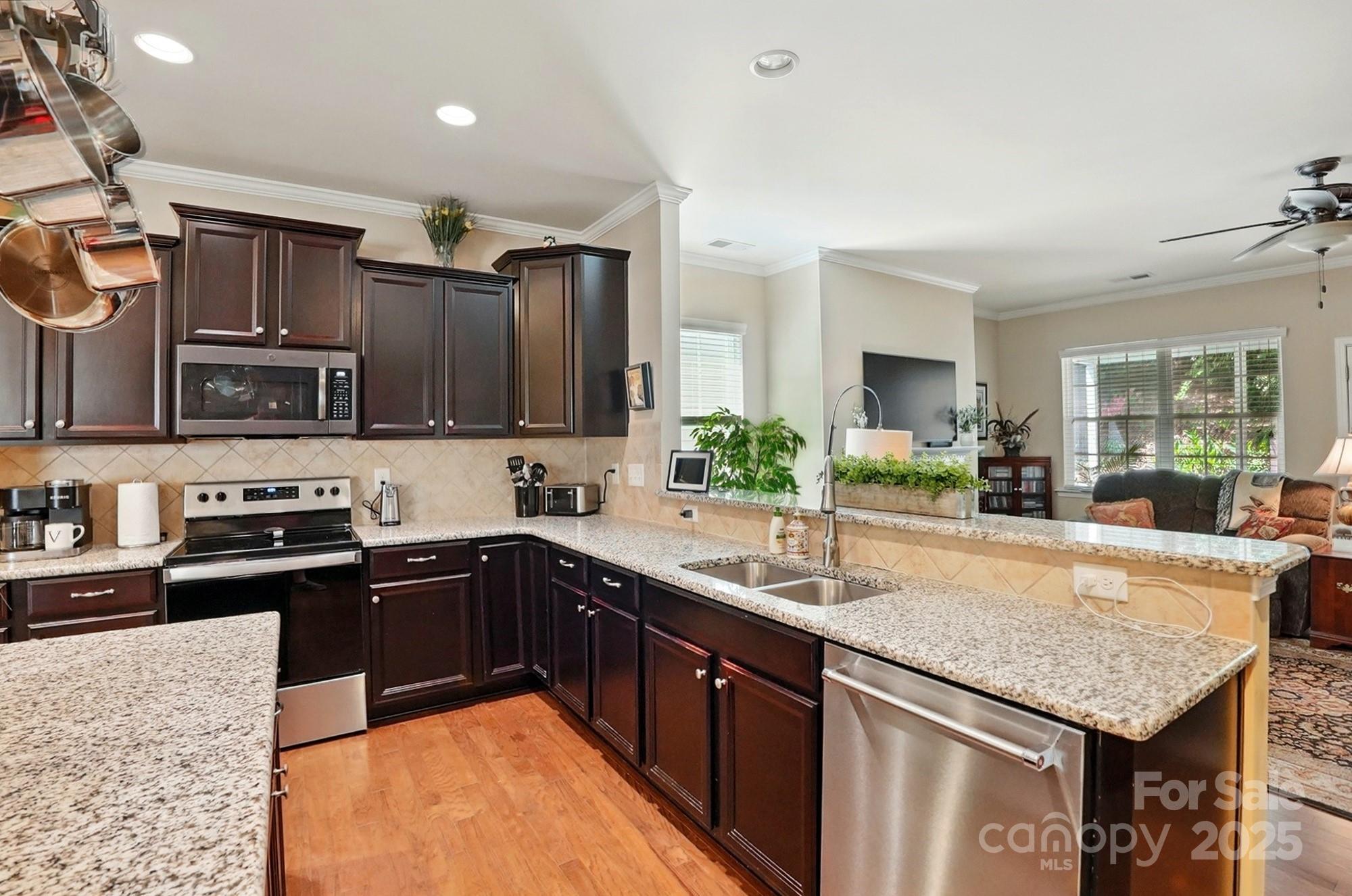 4093 Perth Road Fort Mill, SC 29707 - Photo 9 of 26 a kitchen with stainless steel appliances granite countertop sink stove top oven and cabinets