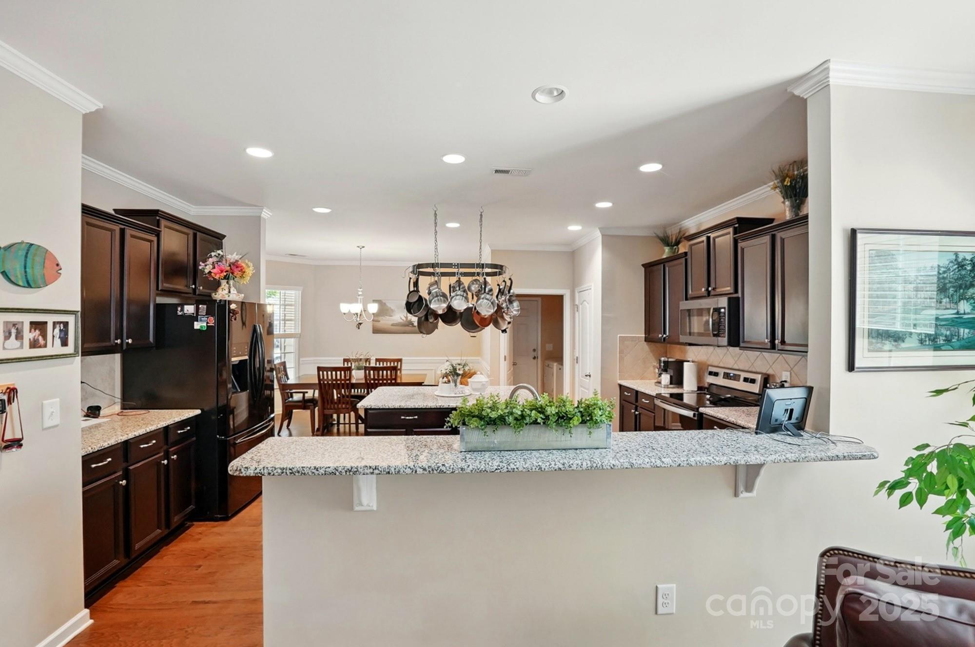 4093 Perth Road Fort Mill, SC 29707 - Photo 10 of 26 a kitchen with stainless steel appliances kitchen island granite countertop a sink and a refrigerator