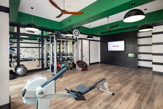 a room with gym equipment and a large window