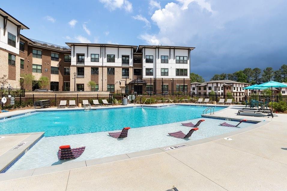 1399 Herrington Road, Unit 9106 Lawrenceville, GA 30044 - Photo 29 of 32 a view of building with outdoor space and swimming pool