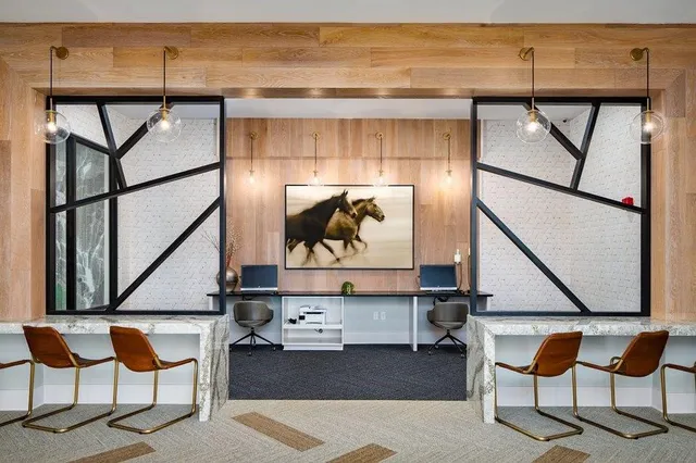 a living room with table and chairs