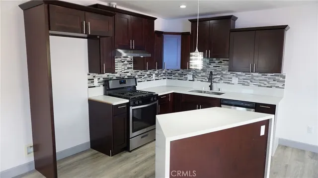 a kitchen with stainless steel appliances granite countertop a stove and a refrigerator