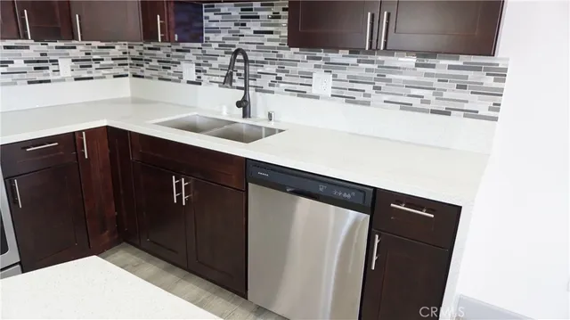 a kitchen with stainless steel appliances a sink stove and cabinets