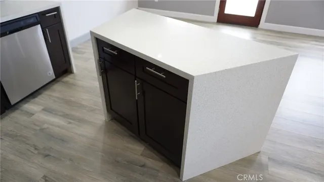an empty room with wooden floor and a flat screen tv