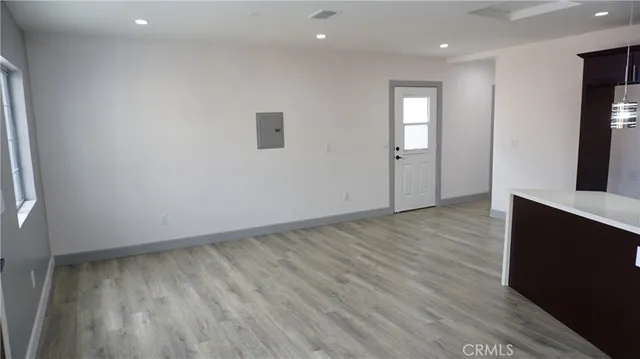 a view of a kitchen with wooden floor