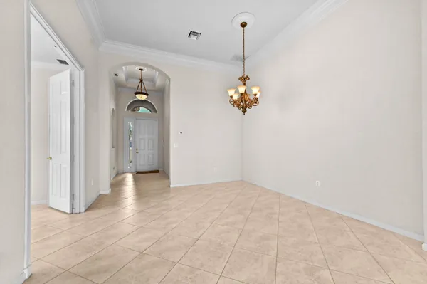 a view of a room with a chandelier fan and windows