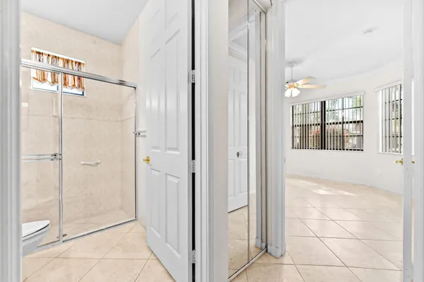 a view of an empty room with window and front door