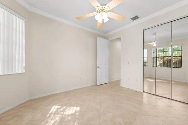 an empty room with fan and windows