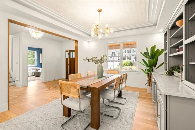 a view of a dining room with furniture and a chandelier