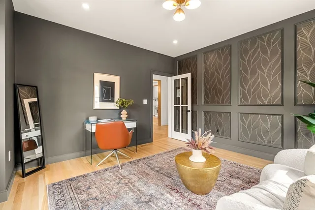 a living room with furniture and a potted plant