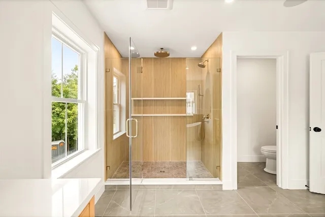 a bathroom with a glass shower door