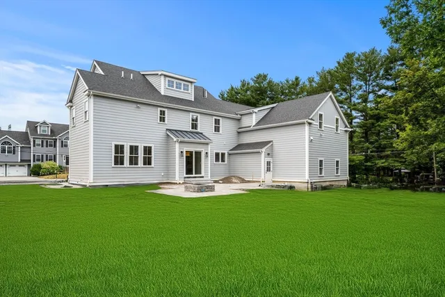 a big white house with a big yard and more windows