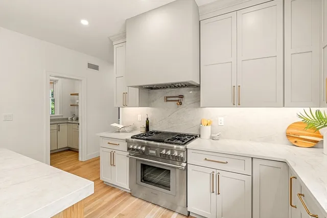 a kitchen with granite countertop a sink cabinets and stainless steel appliances