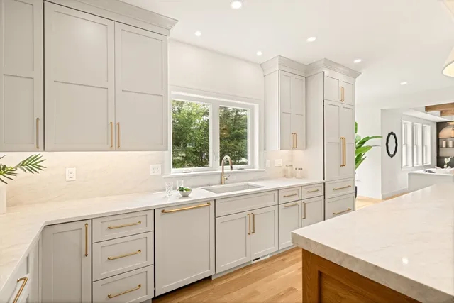 a kitchen with a sink a window and cabinets
