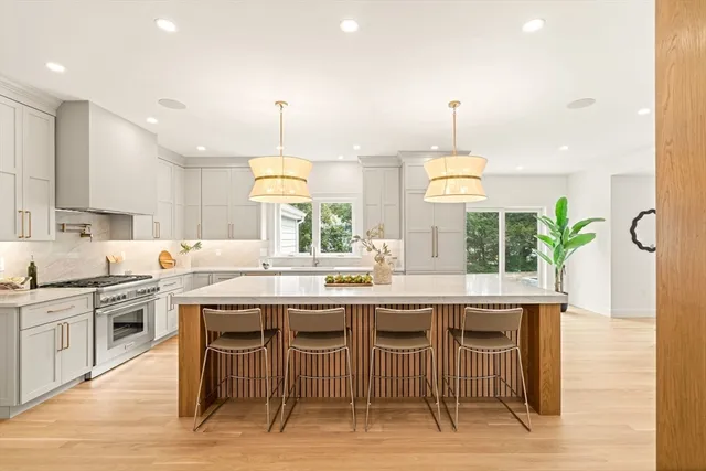 a kitchen with cabinets and wooden floor