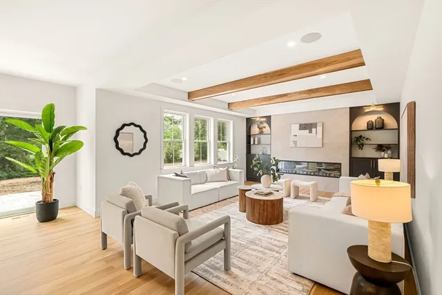 a living room with furniture a chandelier and a window