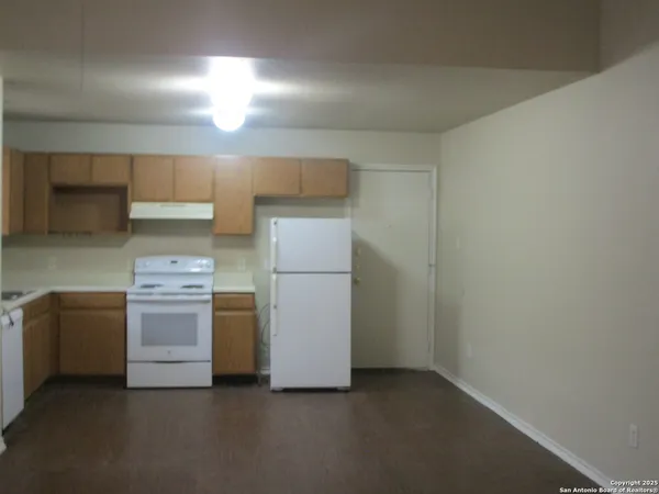 a kitchen with a stove and a refrigerator