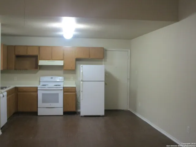a kitchen with a stove and a refrigerator