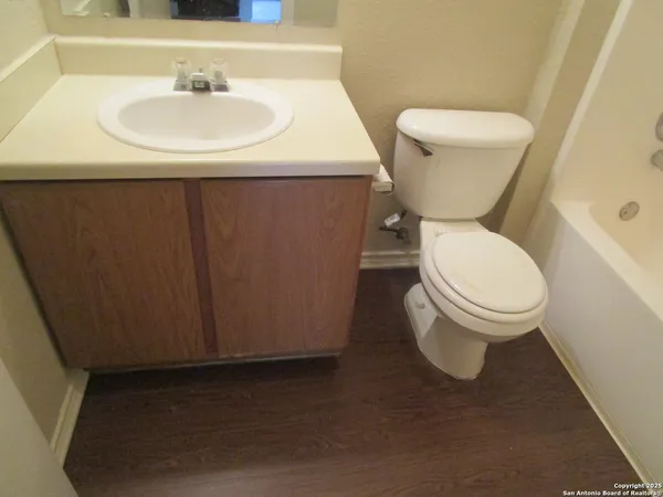 a white toilet sitting next to a bathroom sink