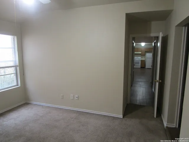 an empty room with closet and mirror