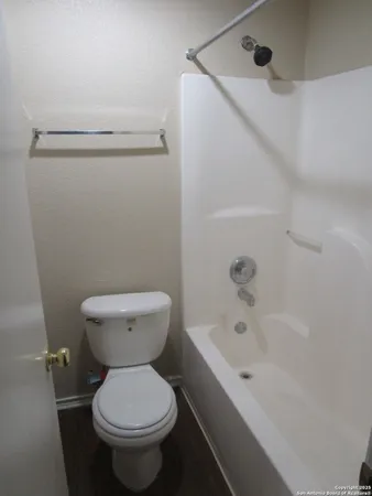 a bathroom with a toilet and a bathtub