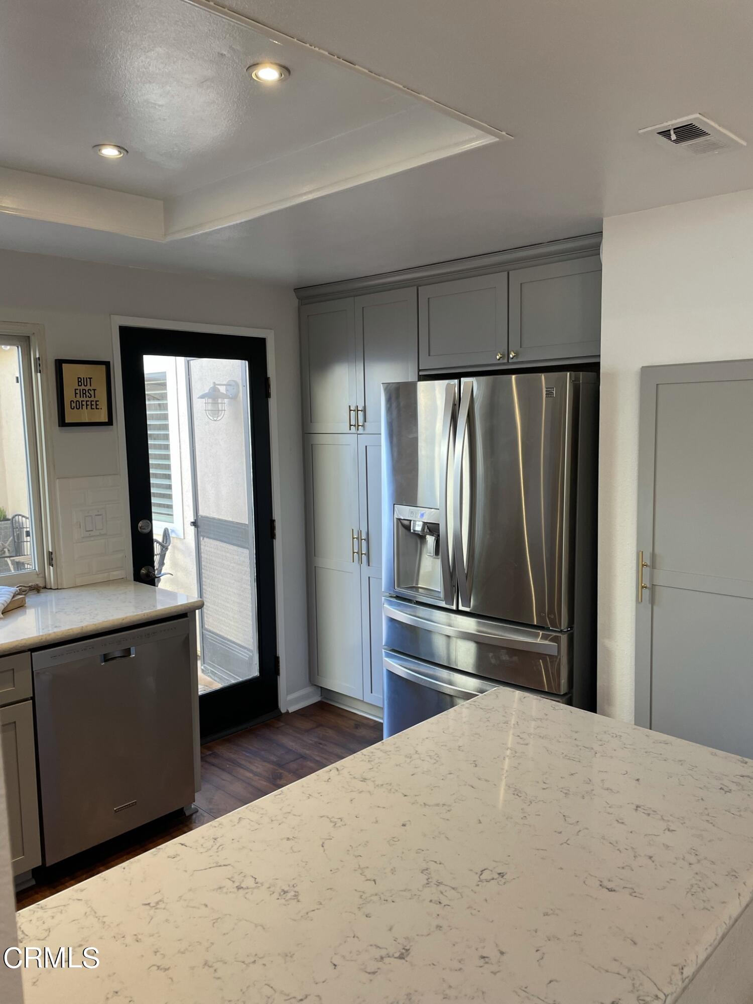 7 Racing Wind Irvine, CA 92614 - Photo 12 of 31 a kitchen with stainless steel appliances a refrigerator and wooden cabinets