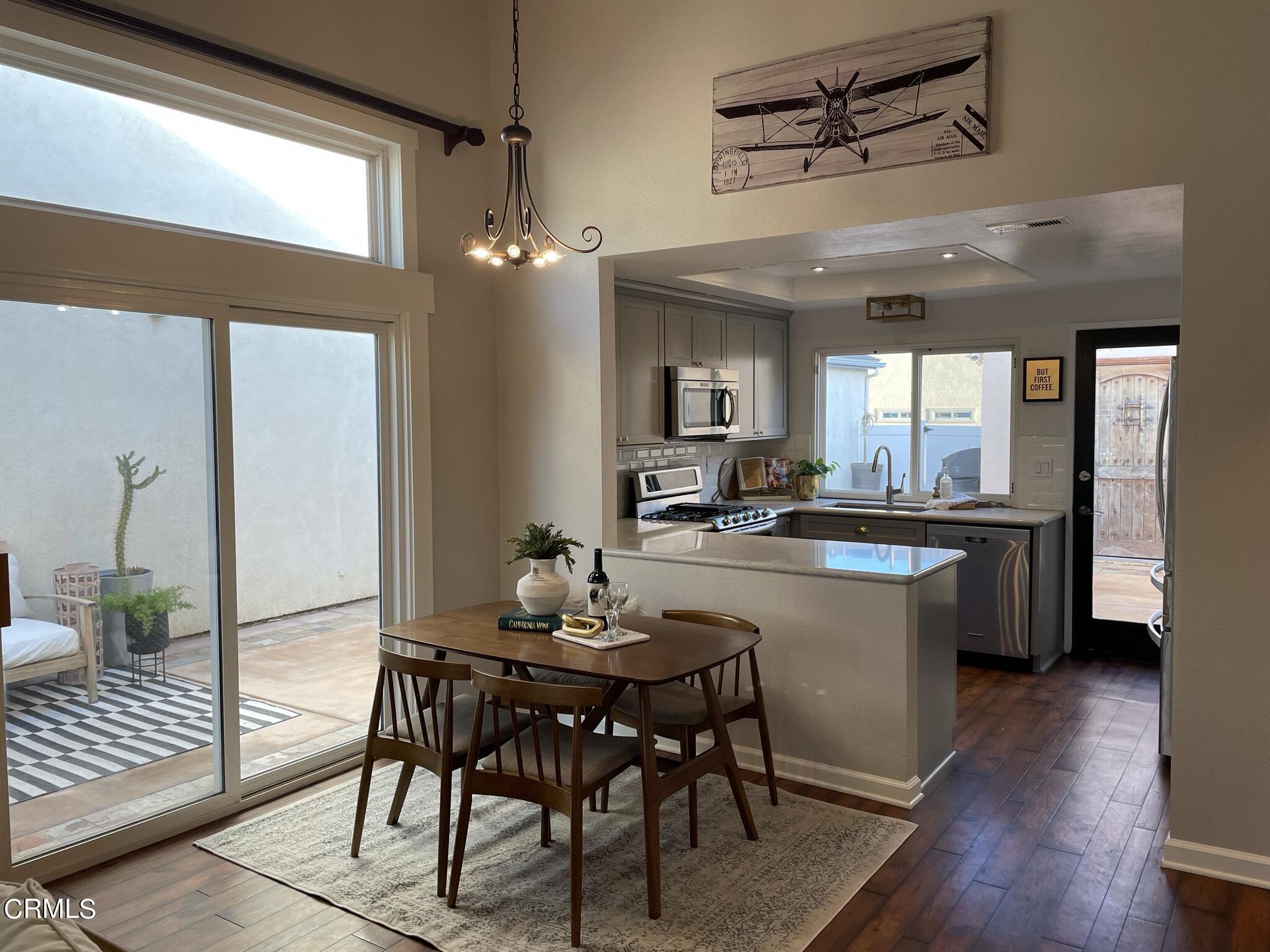 7 Racing Wind Irvine, CA 92614 - Photo 10 of 31 a dining hall with stainless steel appliances kitchen island granite countertop furniture and a large window