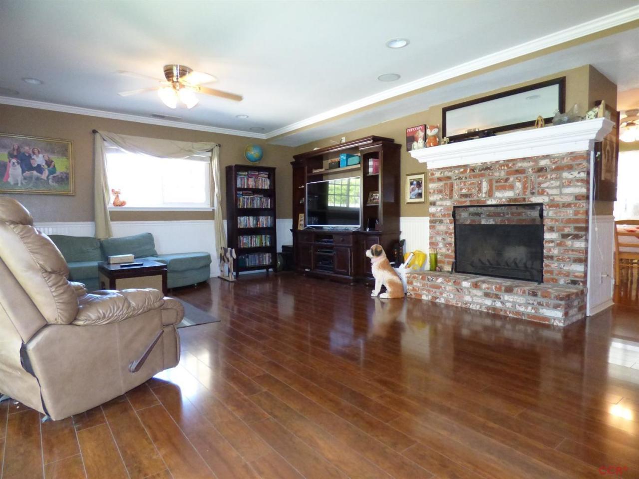 4259 Constellation Road Lompoc, CA 93436 - Photo 3 of 22 a living room with furniture flat screen tv and wooden floor