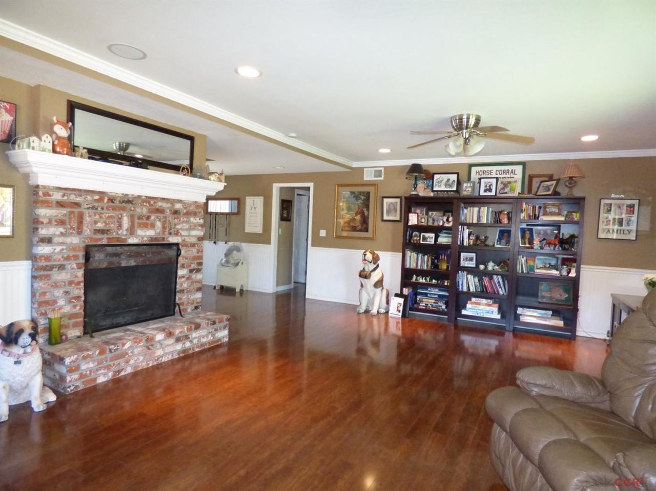 4259 Constellation Road Lompoc, CA 93436 - Photo 4 of 22 a living room with furniture a fireplace and wooden floor