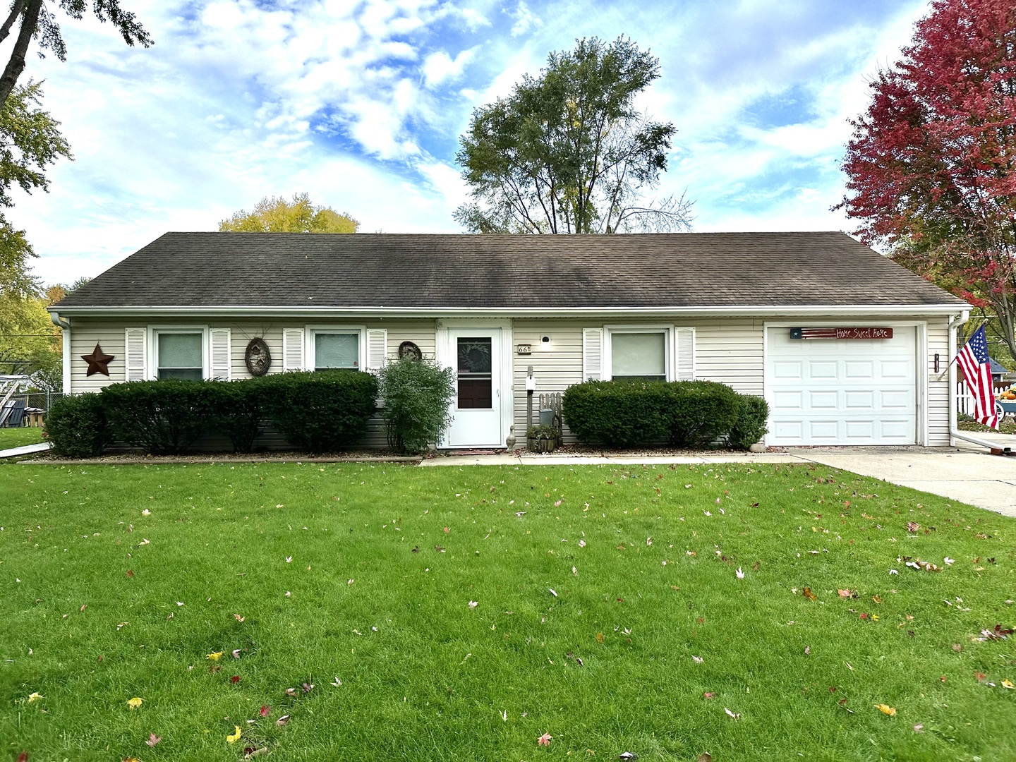 66 Sheffield Road Montgomery, IL 60538 - Photo 1 of 23 a front view of a house with a garden