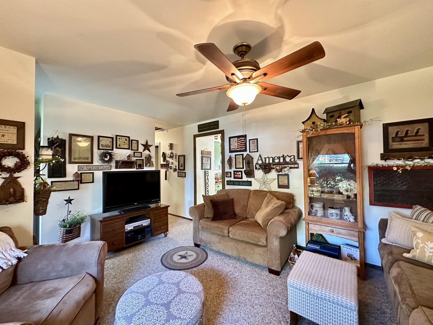 66 Sheffield Road Montgomery, IL 60538 - Photo 11 of 23 a living room with furniture workspace and a flat screen tv