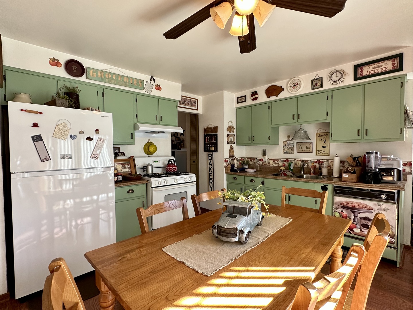 66 Sheffield Road Montgomery, IL 60538 - Photo 12 of 23 a kitchen with stainless steel appliances kitchen island granite countertop a table chairs and a refrigerator