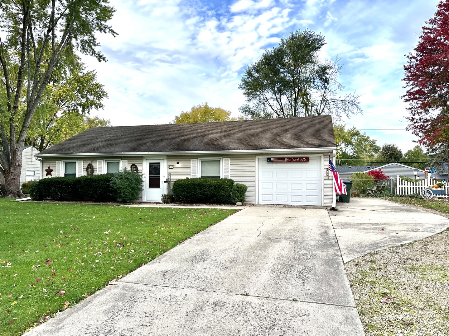66 Sheffield Road Montgomery, IL 60538 - Photo 3 of 23 a front view of a house with a yard and garage