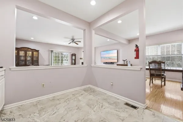 a view of a livingroom with furniture a ceiling fan and window