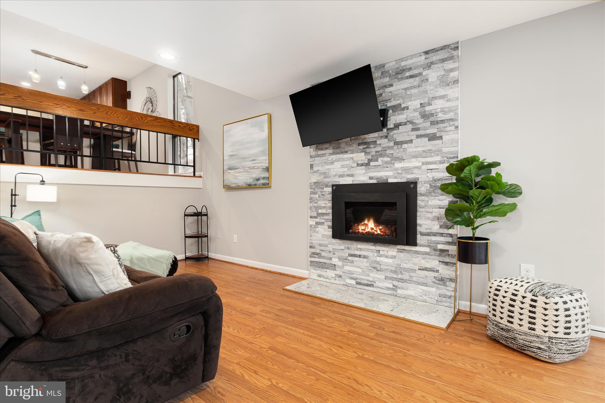 11608 Newbridge Court Reston, VA 20191 - Photo 13 of 47 a living room with furniture a fireplace and a flat screen tv