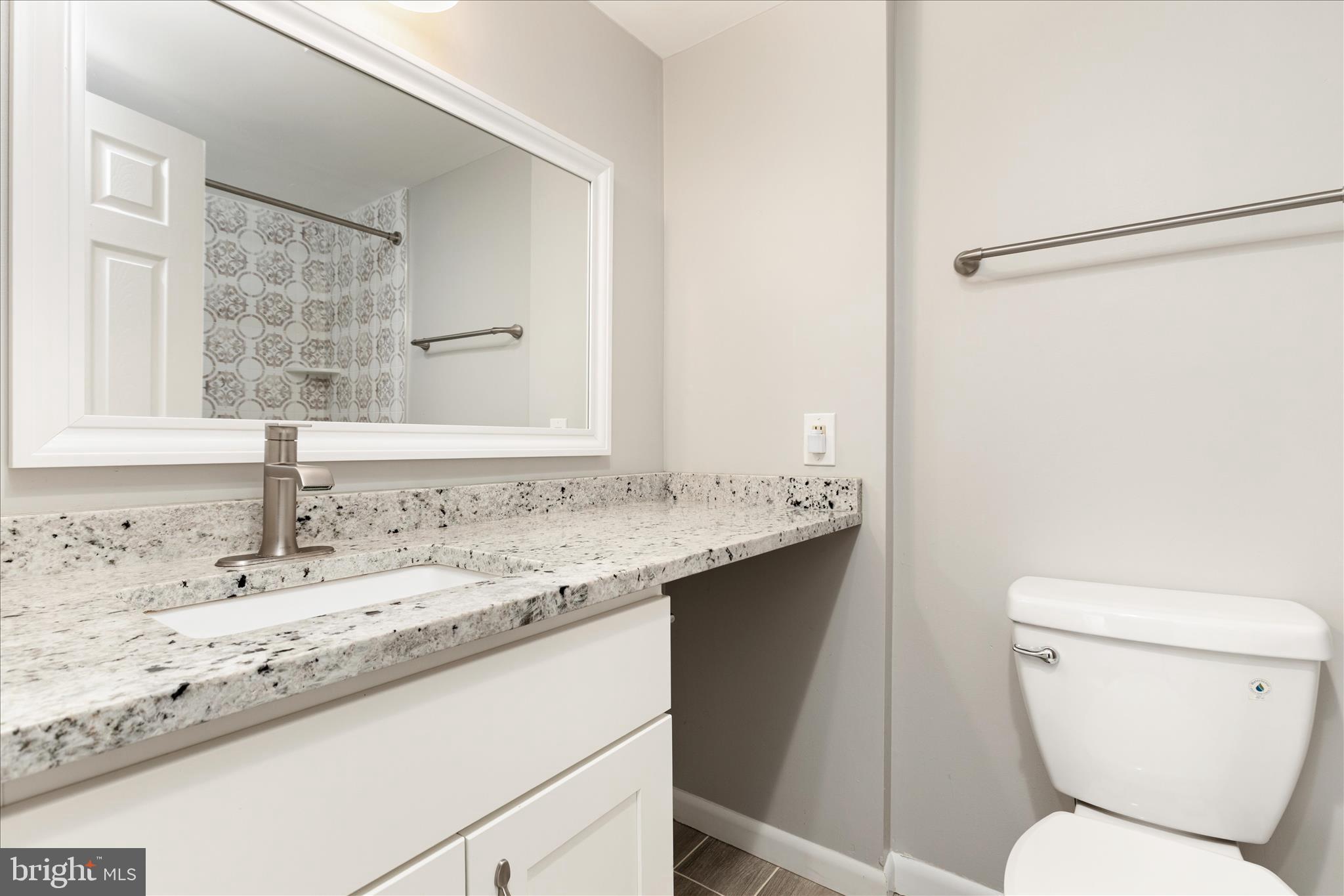 11608 Newbridge Court Reston, VA 20191 - Photo 30 of 47 a bathroom with a granite countertop sink toilet and shower