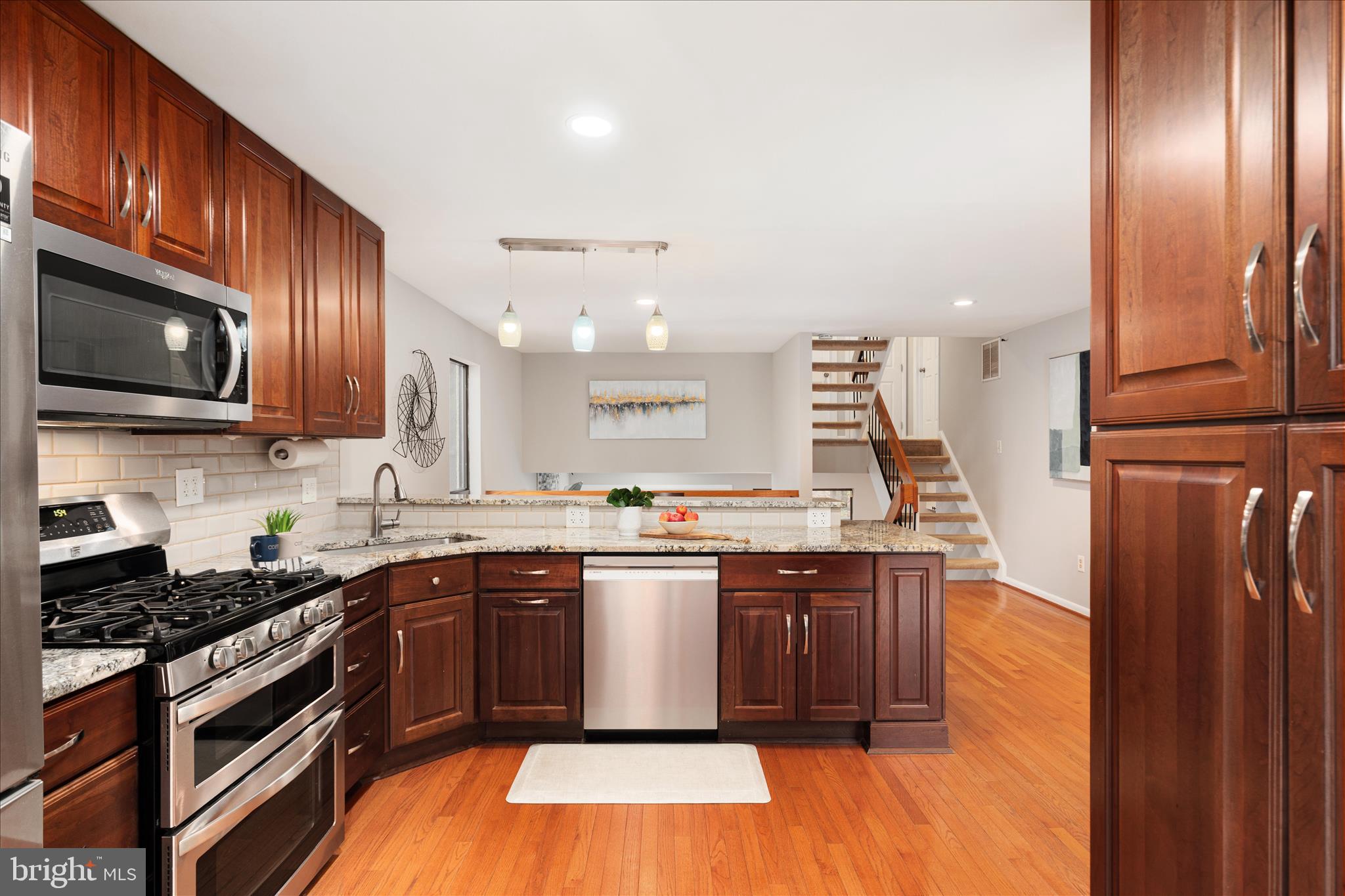 11608 Newbridge Court Reston, VA 20191 - Photo 9 of 47 a kitchen with stainless steel appliances granite countertop wooden cabinets a sink dishwasher a stove and a refrigerator