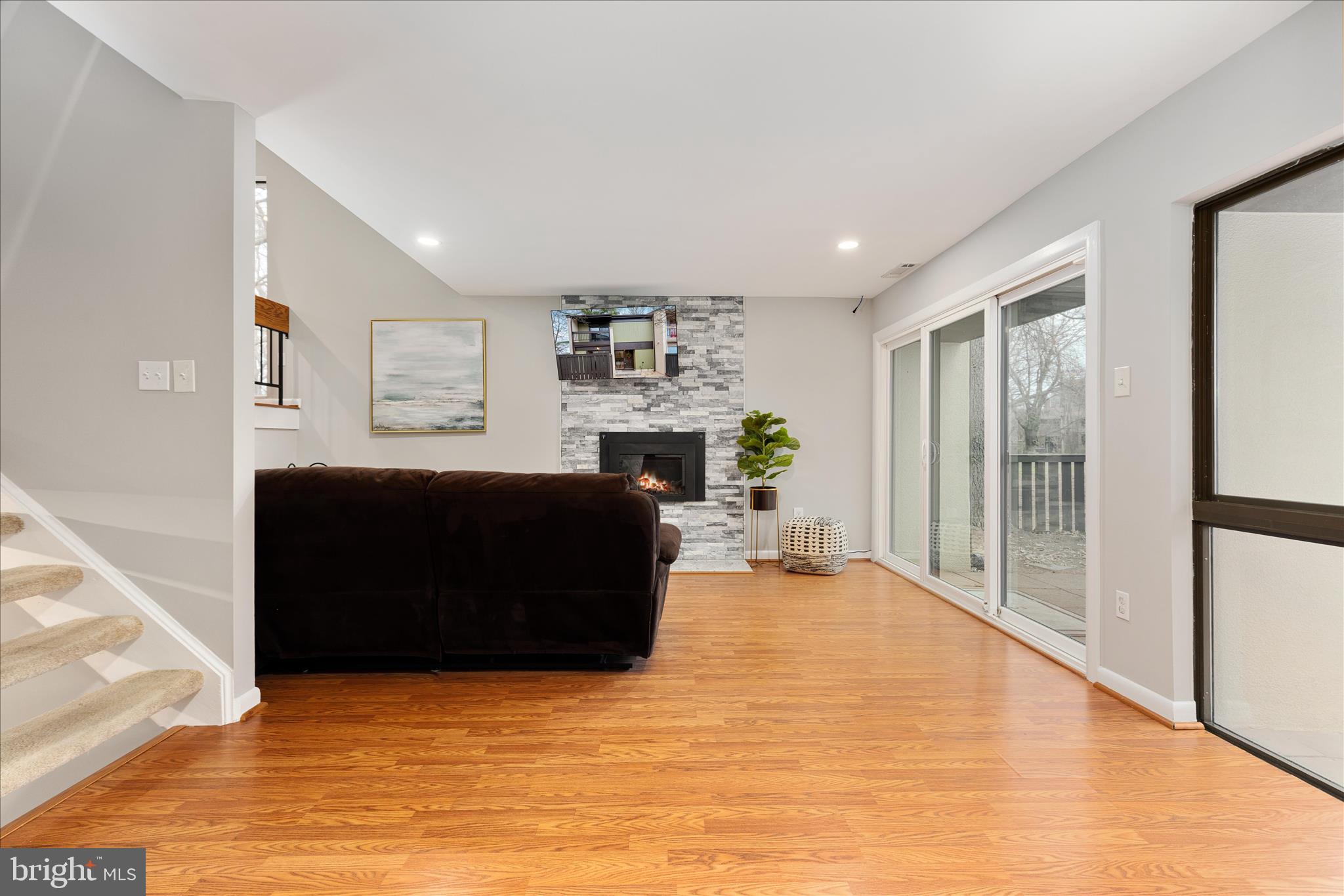 11608 Newbridge Court Reston, VA 20191 - Photo 10 of 47 a living room with furniture a flat screen tv and a fireplace