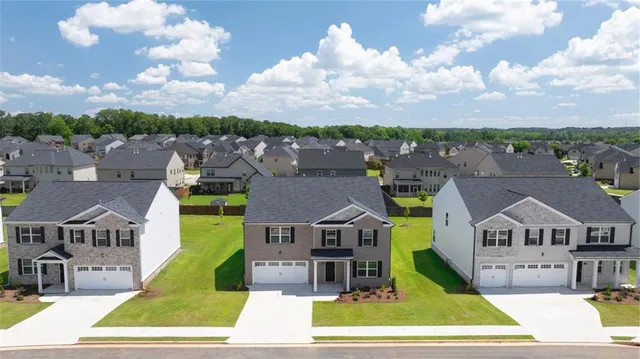 an aerial view of a house with a big yard
