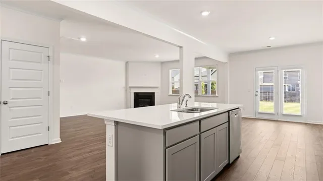 a view of a small space with wooden floor and windows