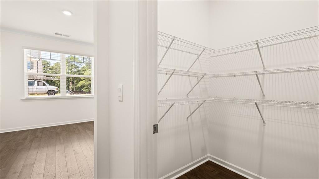 71 Weymouth Drive Locust Grove, GA 30248 - Photo 12 of 56 a view of a small space with wooden floor and windows